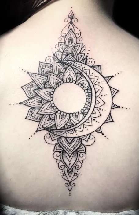 Intricate mandala sun and crescent moon tattoo on the back