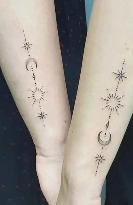 Matching sun and crescent moon tattoos with stars and geometric designs on forearms