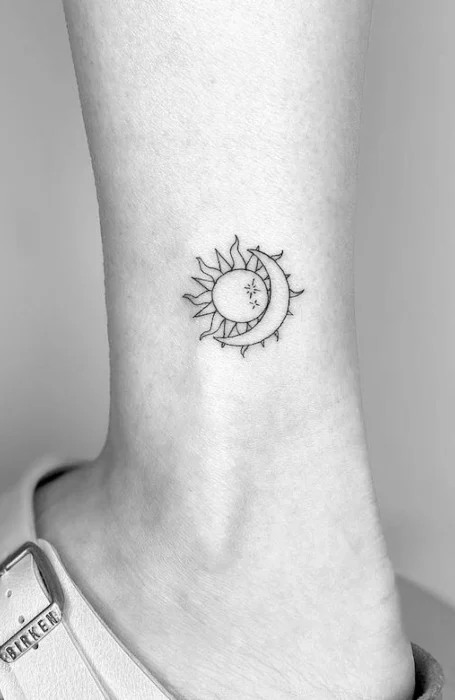 Small sun and crescent moon tattoo on the ankle