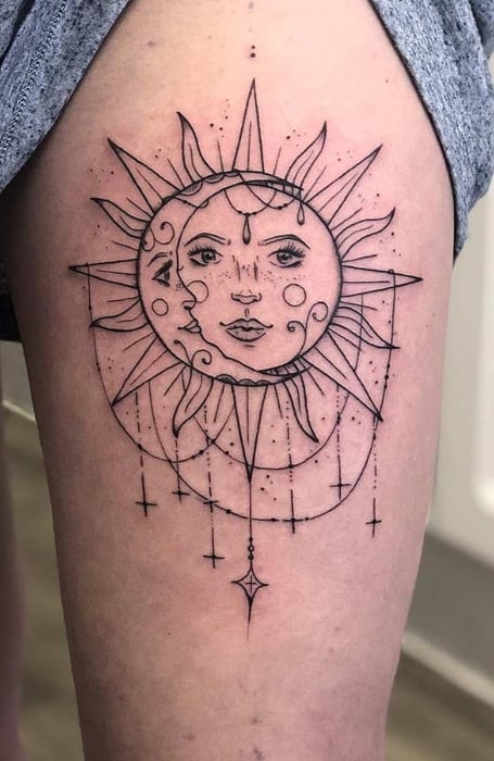 Detailed sun and moon face tattoo with geometric elements on the thigh