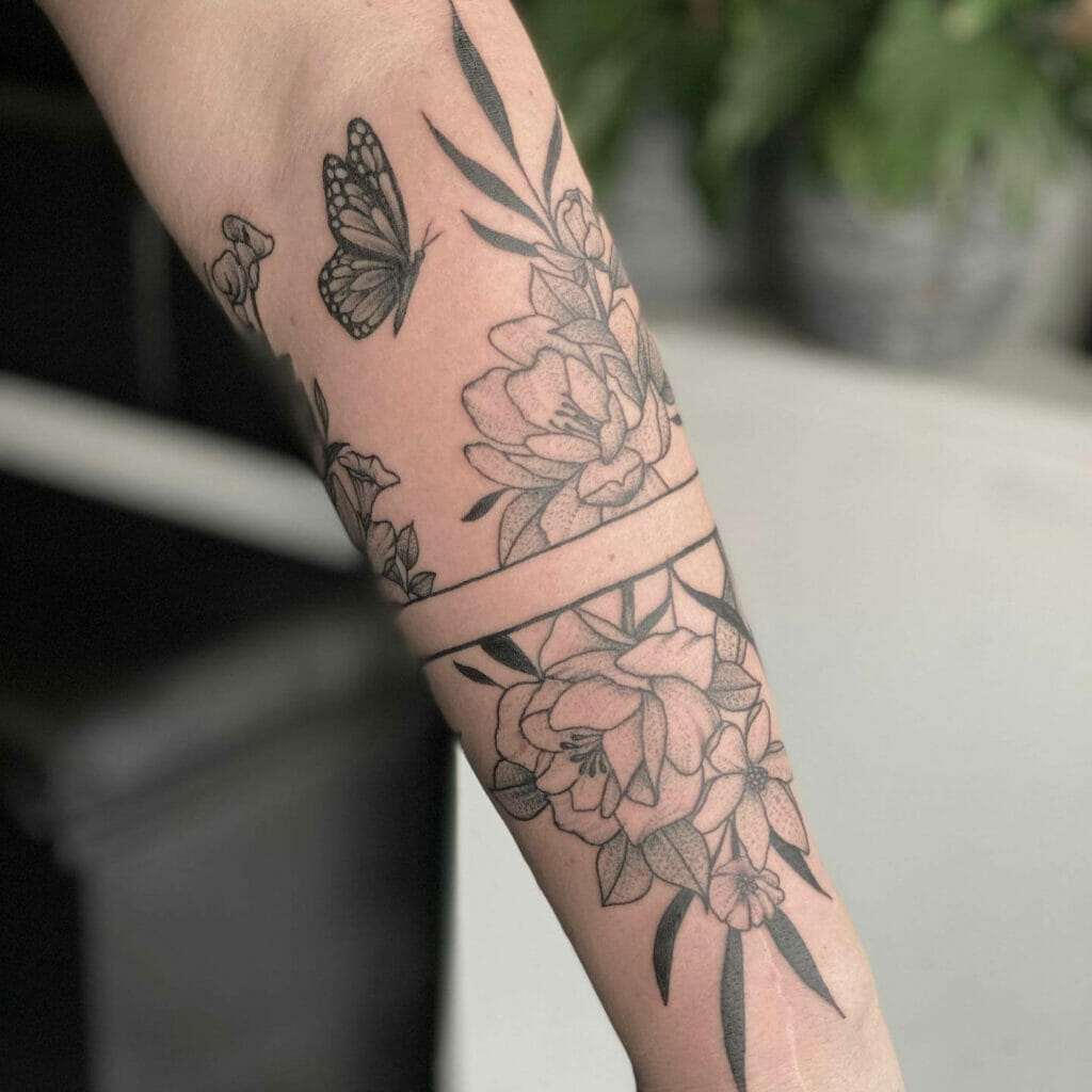 Floral Forearm Tattoo with Butterfly and Negative Space Band