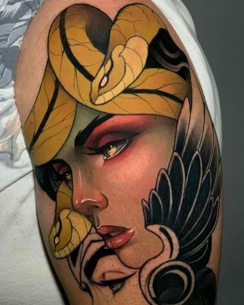 Medusa-inspired tattoo featuring a woman's face with golden snakes and intricate black wing details