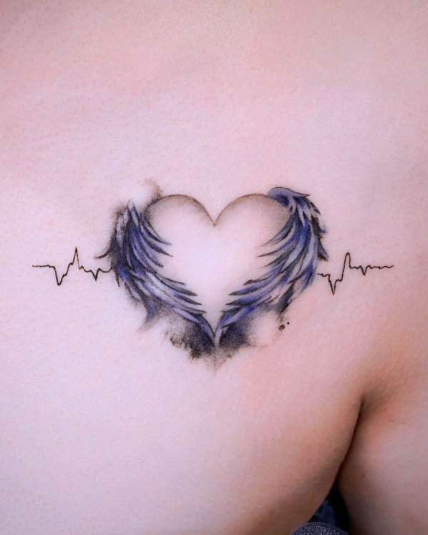 Winged heart tattoo with heartbeat line in blue and gray tones on chest