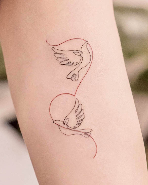 Minimalist doves and heart tattoo with black and red linework on the arm