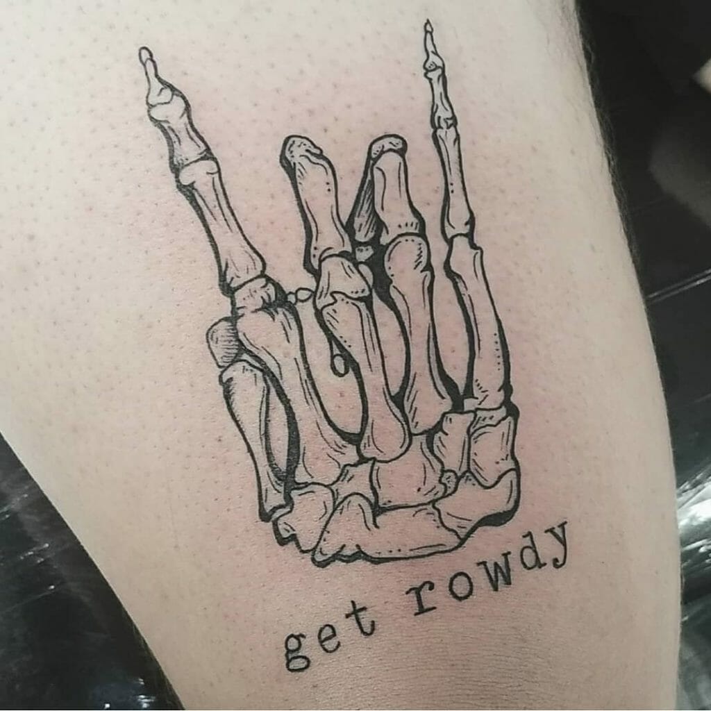 Skeleton hand tattoo in rock 'n' roll sign pose with the text 'get rowdy' beneath it