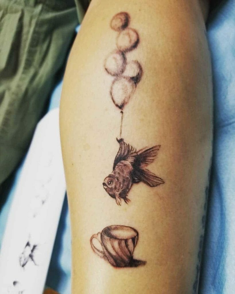 Whimsical Fish Tattoo Design with Balloons and Cup