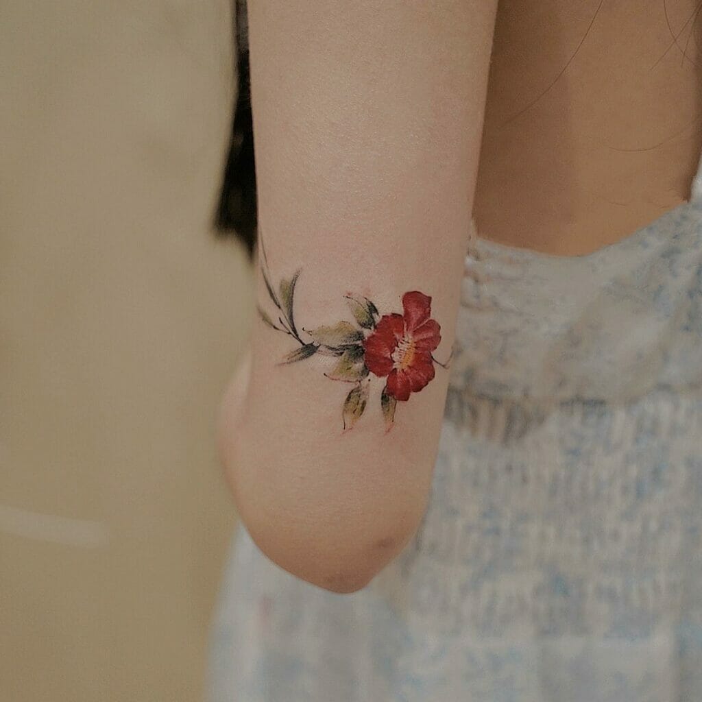 Minimalist Red Flower Arm Tattoo with Watercolor Style