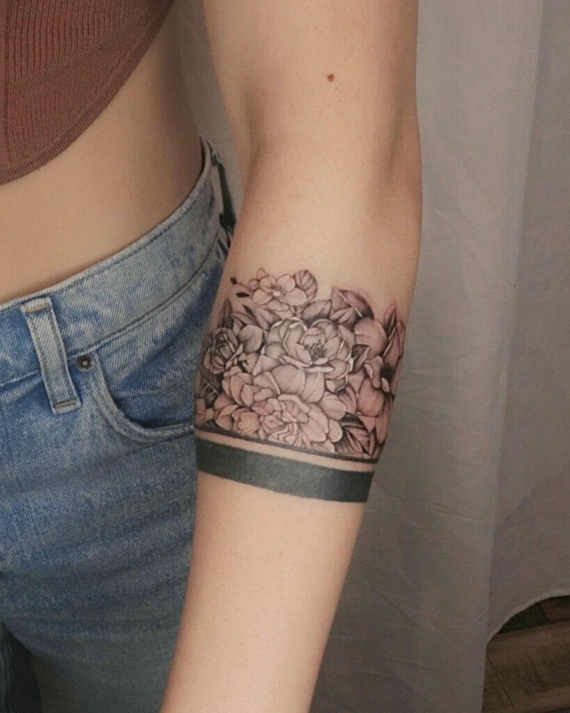 Realistic Floral Arm Tattoo with Bold Black Band