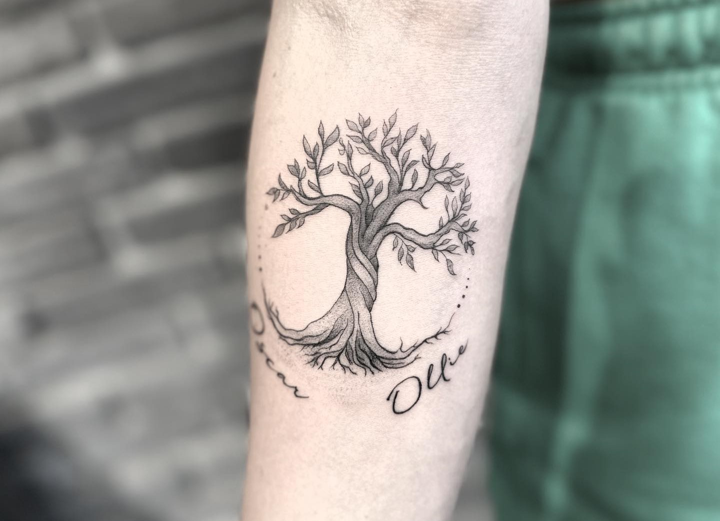 Minimalist Tree of Life tattoo with detailed branches and roots on the forearm