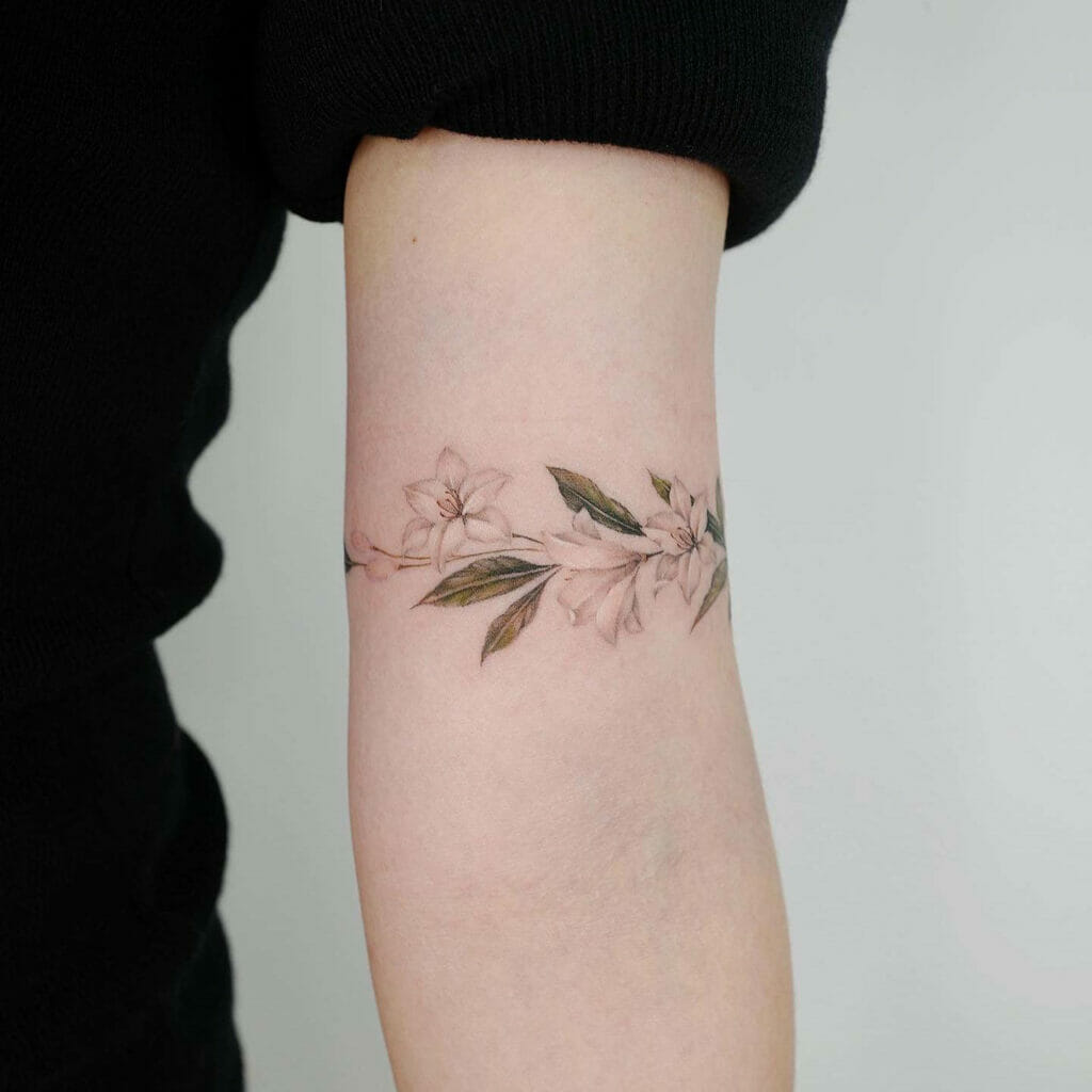 Delicate Floral Armband Tattoo with Soft Pastel Colors