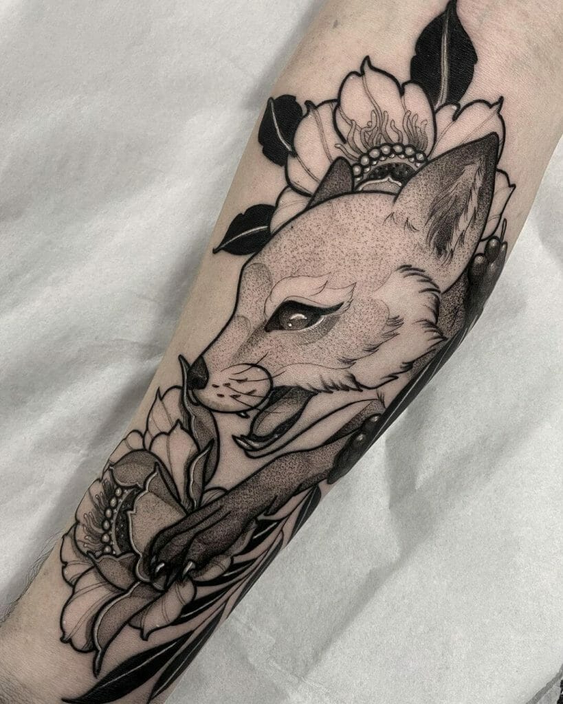 Elegant black and gray fox tattoo surrounded by detailed flowers and leaves with intricate shading