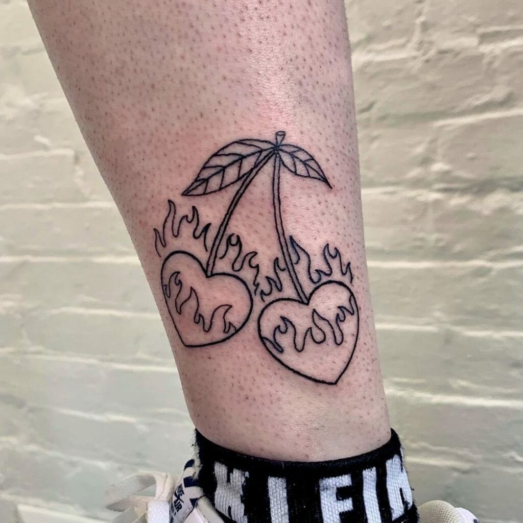 Flaming heart cherry tattoo on lower leg with black linework, minimalist style