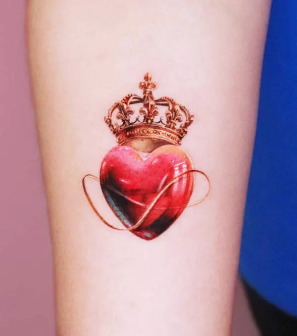 Crowned heart tattoo with a glossy red heart and ornate golden crown