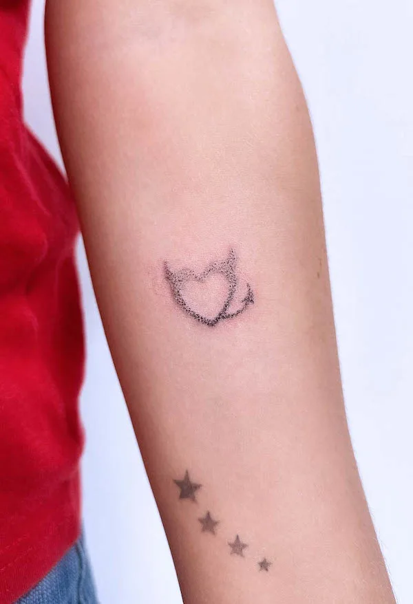 Dotted devil heart tattoo on the arm, symbolizing the playful and mischievous side of love