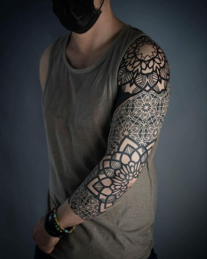 Elaborate black floral sleeve tattoo