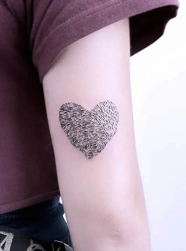 Minimalistic fingerprint heart tattoo symbolizing uniqueness and personal connection