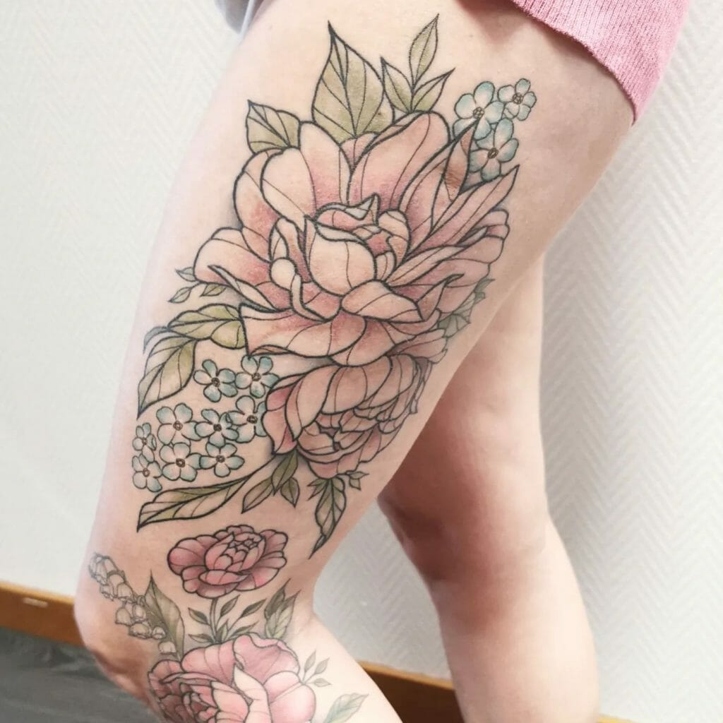 Delicate floral thigh tattoo featuring pastel pink roses, blue blossoms, and green leaves with fine details