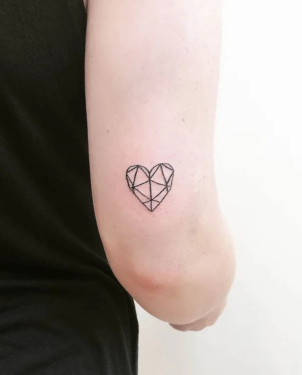 Geometric heart tattoo with black linework, symbolizing balance and structured love