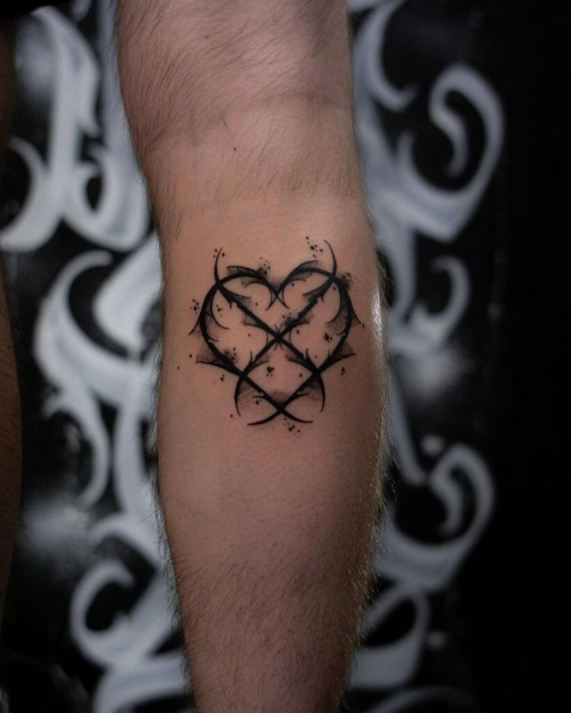 Abstract tribal heart tattoo with barbed wire design and black ink on the calf