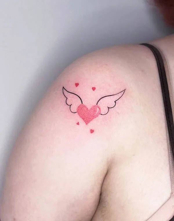 Winged heart tattoo with soft pink shading and small hearts symbolizing freedom and love