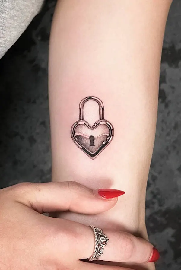 Heart-shaped padlock tattoo with a keyhole, symbolizing love, protection, and secrecy