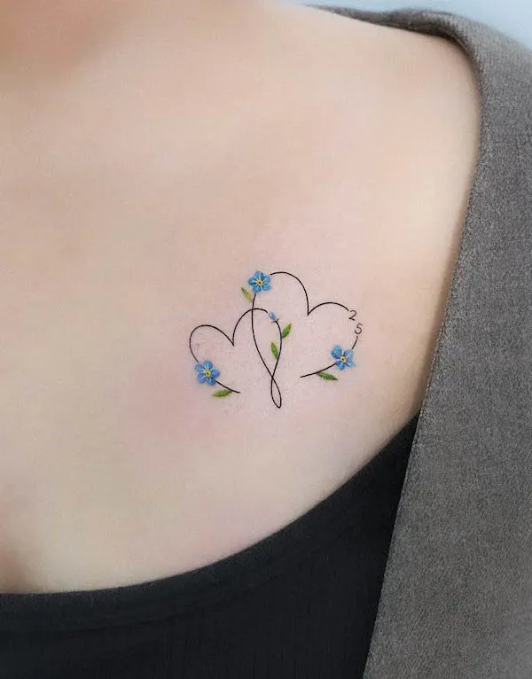 Floral dual heart tattoo with blue flowers and number "25" symbolizing love and growth