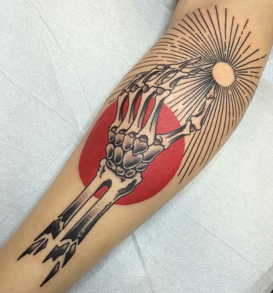 Skeleton hand tattoo reaching for the sun with a bold red circle background and radiant sun rays