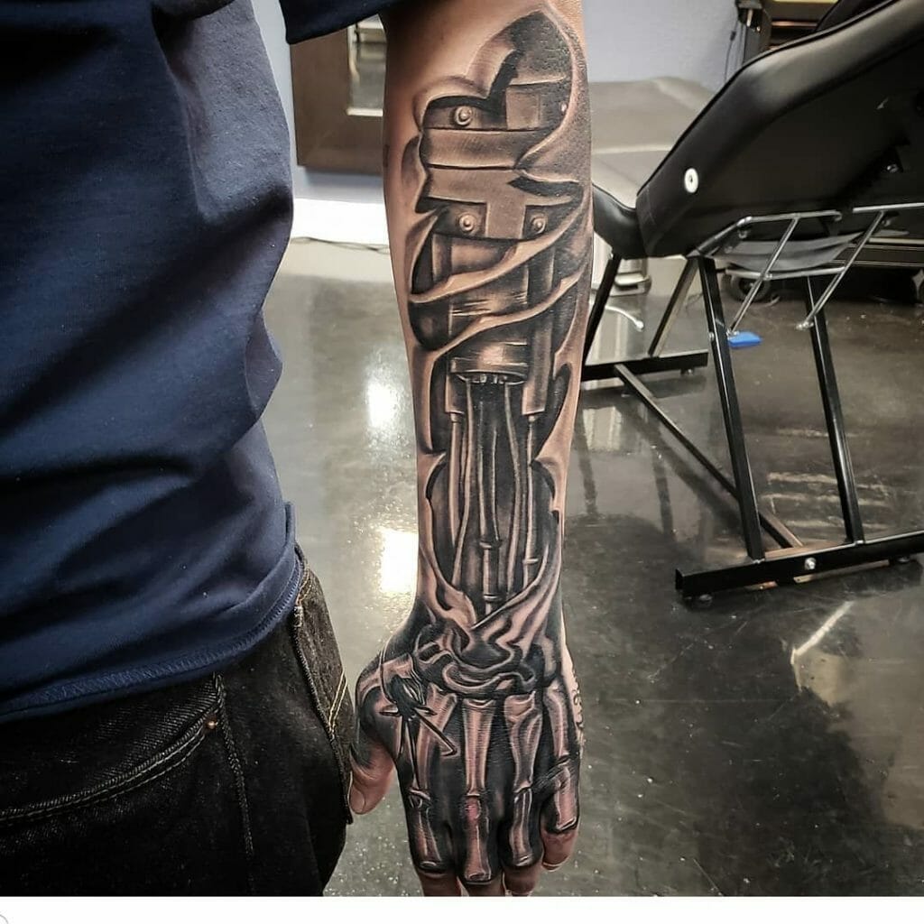 Biomechanical skeleton hand tattoo with intricate metallic and robotic design extending onto the forearm