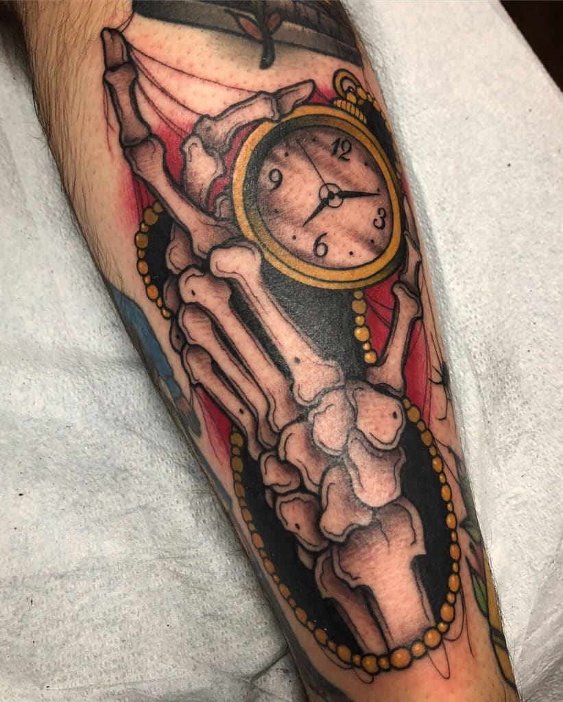 Skeleton hand tattoo holding a vintage clock with intricate details and vibrant colors