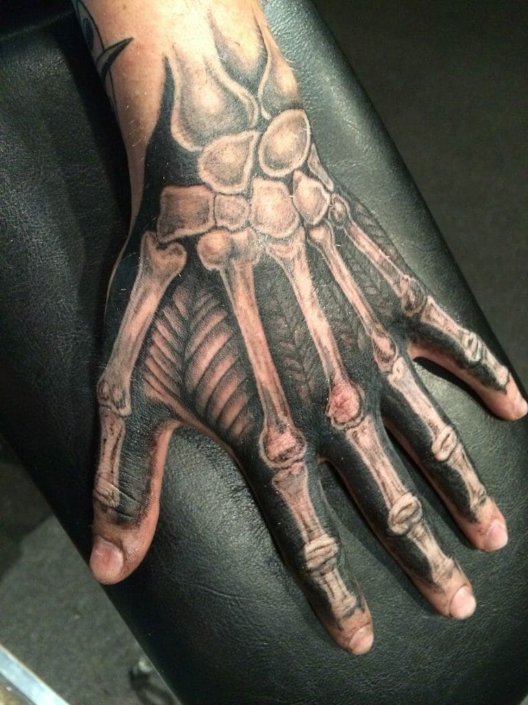 Realistic skeleton hand tattoo with detailed bone shading and anatomical accuracy