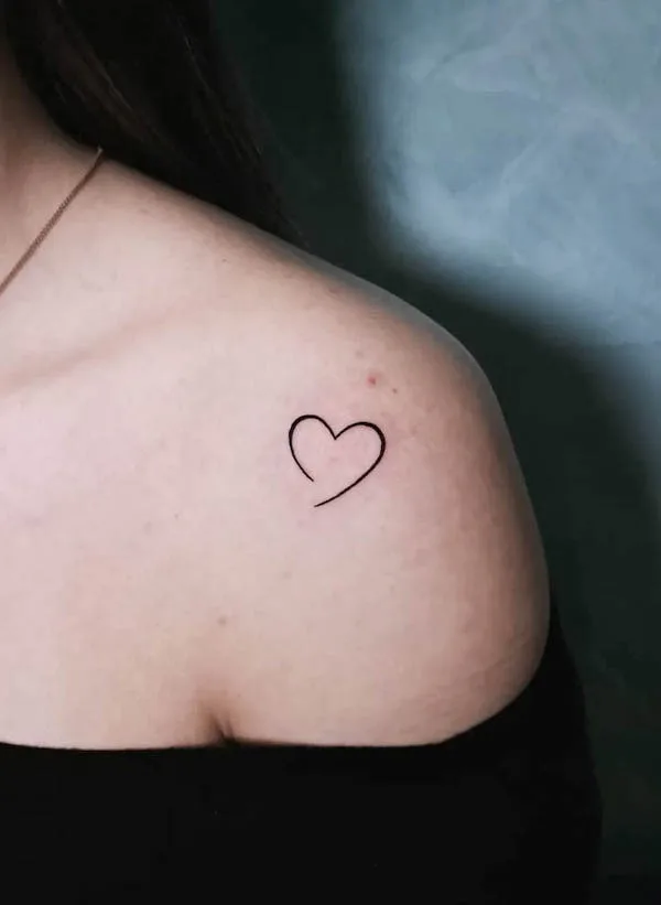 Minimalist heart outline tattoo on the shoulder symbolizing love and simplicity