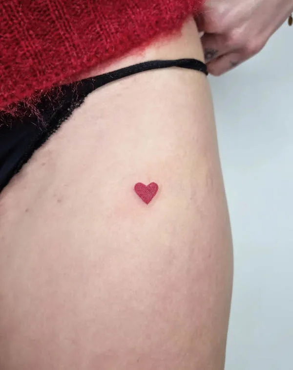 Geometric heart tattoo with intricate patterns and sharp black lines