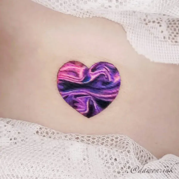 Purple and pink marble heart tattoo with swirling patterns and deep hues