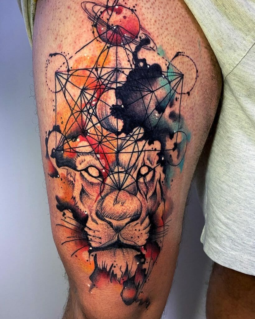 Thigh tattoo of a lion's face with abstract geometric patterns and cosmic elements, incorporating watercolor effects in vibrant colors.