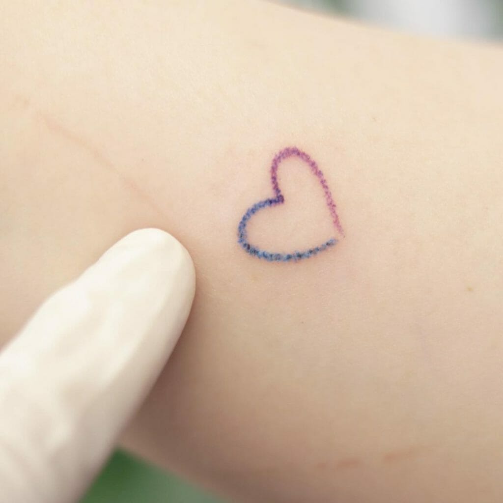 Minimalist multicolor heart tattoo with pink and blue gradient on skin