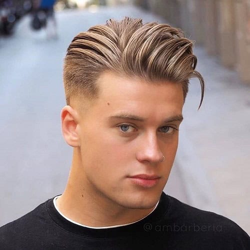 Young man with a slicked-back crew cut hairstyle featuring a fade, wearing a black shirt.