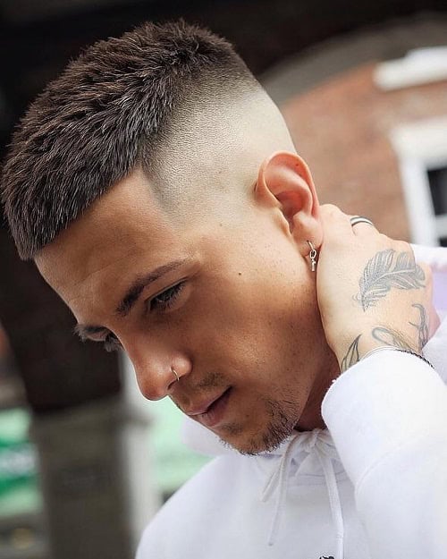 Man with a high fade crew cut hairstyle, sporting a clean and sharp fade, wearing a white hoodie.