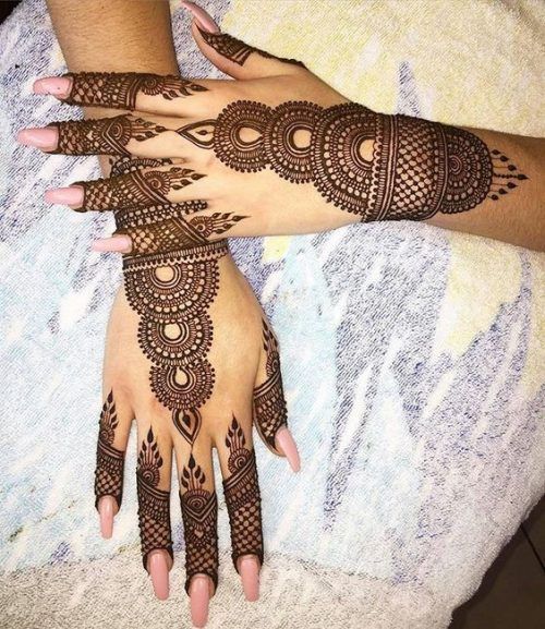 Intricate bridal Mehndi design with circular motifs and mesh patterns covering the back of both hands, ideal for weddings