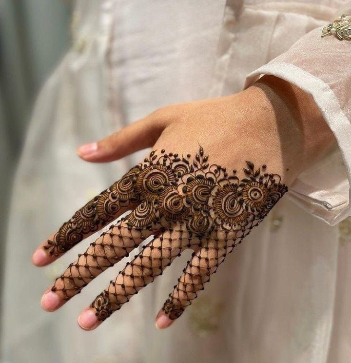 Floral Mehndi design on the back of the hand with intricate mesh detailing on the fingers, perfect for modern and traditional occasions