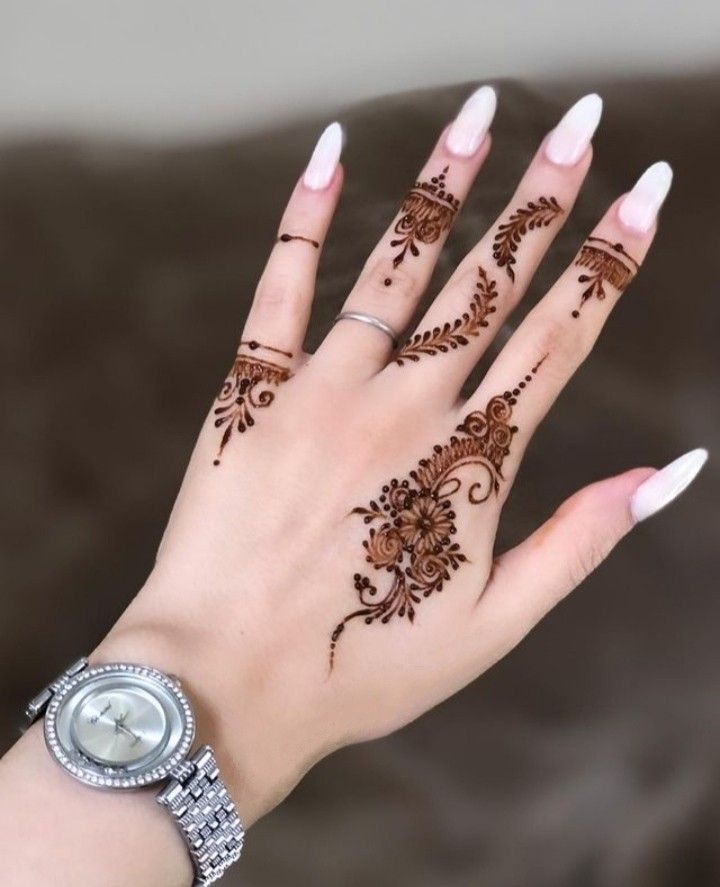 Minimalistic Mehndi design featuring floral accents on the back of the hand and fingers, perfect for modern and casual occasions