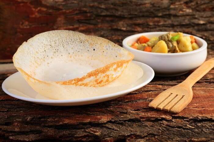 Kerala-style Appam, a lacy rice pancake, served with a bowl of vegetable stew (Ishtu).