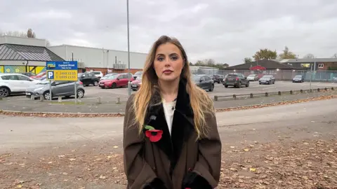 Rosey Hudson standing in front of the car park