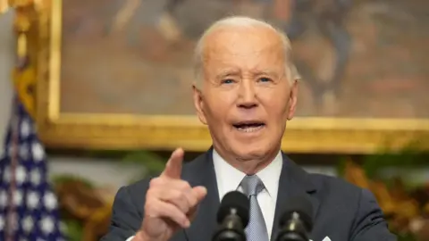 Reuters President Biden speaks to reporters from a podium inside the White House after the fall of Bashar al-Assad.