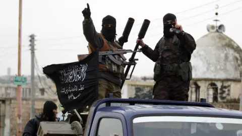 Reuters Al-Nusra Front fighters ride on a pick-up truck carrying an anti-aircraft gun in Idlib province, north-western Syria (2 December 2014)