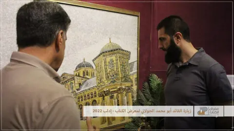 Salvation Government Abu Mohammed al-Jawlani visiting a book, arts and culture fair in Idlib in 2022