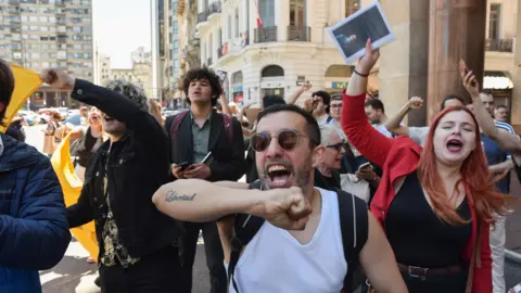 Reuters Supporters of Argentina's President Javier Milei shout slogans on the day of the Mercosur summit in Montevideo, Uruguay, 6 December 2024