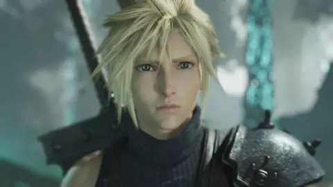 Square Enix A computer-generated image shows a blond male character with asymmetrical spiky hair looking forlorn as he stares into the distance. The hilt of an oversized sword strapped to his back is visible.