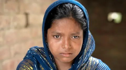 Ronny Sen for the BBC Sabina Khatun, wearing a shawl, looks sad