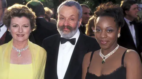 Getty Images British Film director Mike Leigh, surrounded by Brenda Blethyn (R) and Marianne Jean-Baptiste (L) arrives for the screening of his film Secrets & Lies, on May 10, 1996 during the Cannes International Film Festival