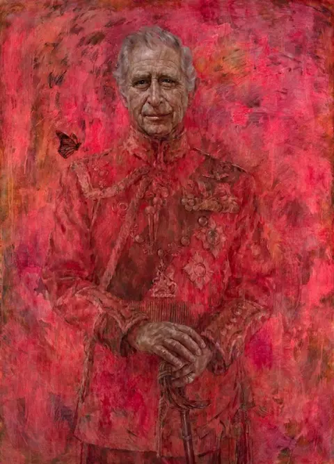 Jonathan Yeo Studio King Charles with a butterfly near his shoulder, painted in a flaming red military outfit and matching background